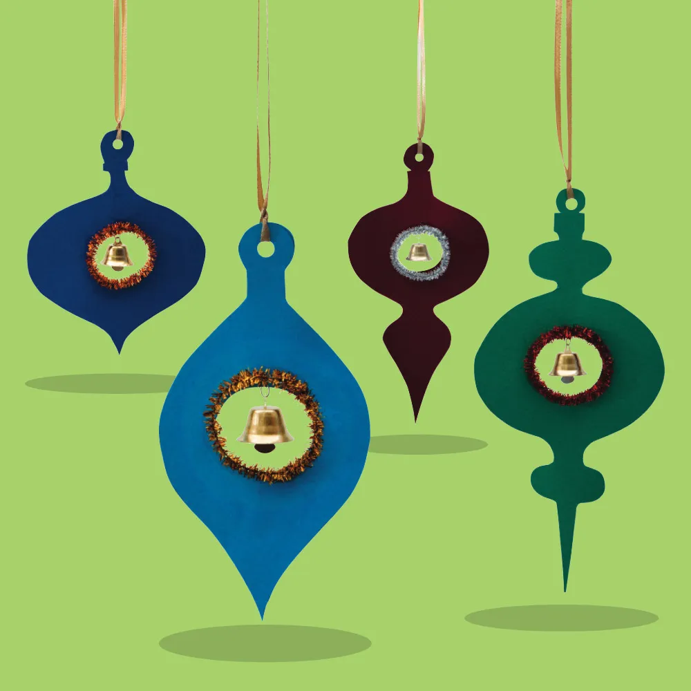 Four hanging Christmas ornaments cut in classic mid-century shapes from coloured foam, each featuring a gold jingle bell in the centre surrounded by tinsel and suspended with gold ribbon.