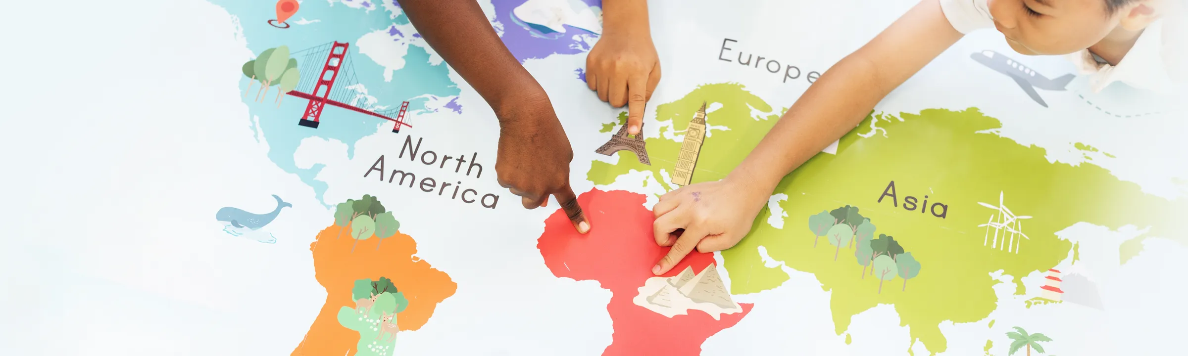 Children pointing to places on a map